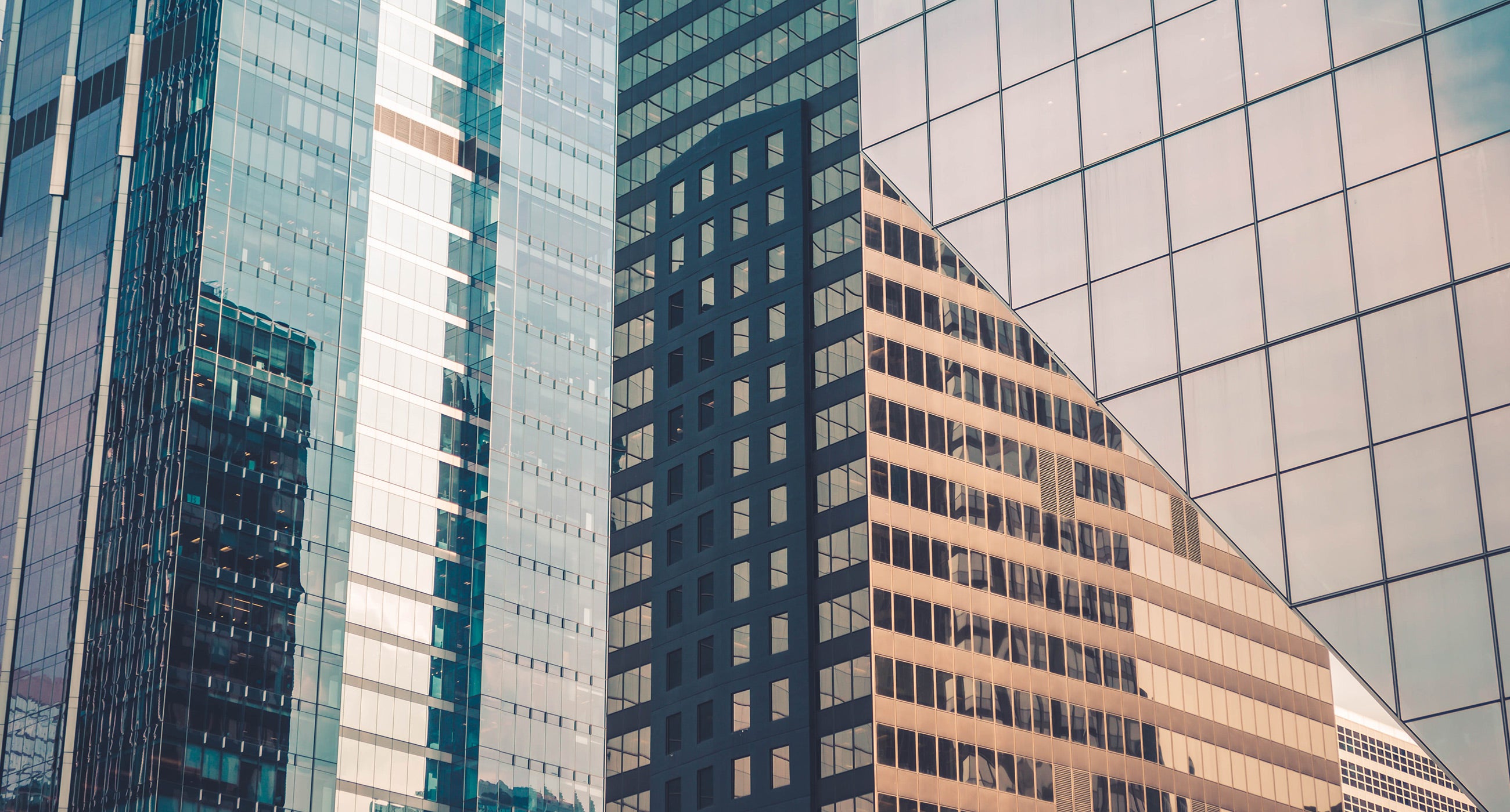 Glass office buildings reflecting sunlight