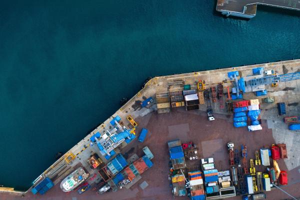 Aerial view of water and dock covered in shipping containers