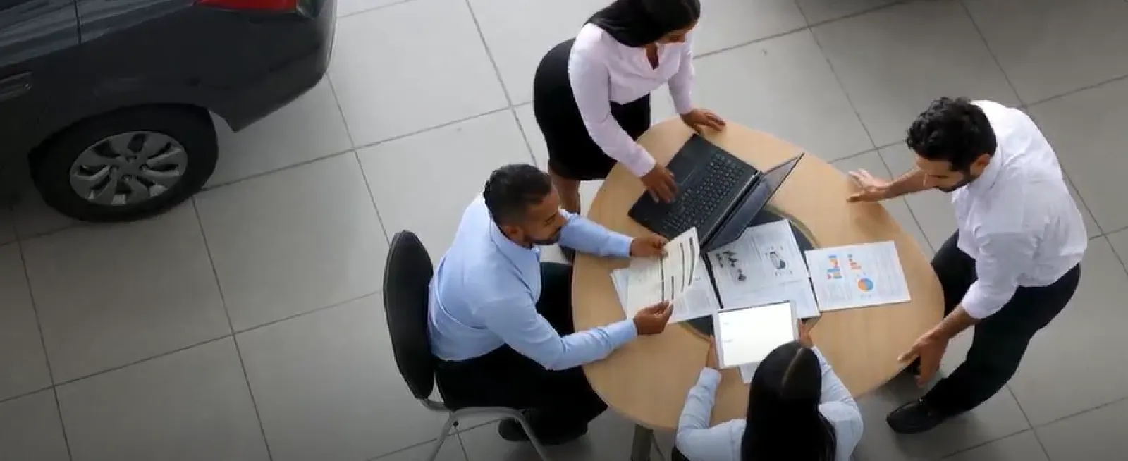 Group of people at an automotive dealer showroom